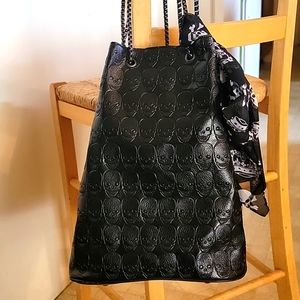 Vegan black skull embossed bucket bag. Comes with makeup bag and scarf.